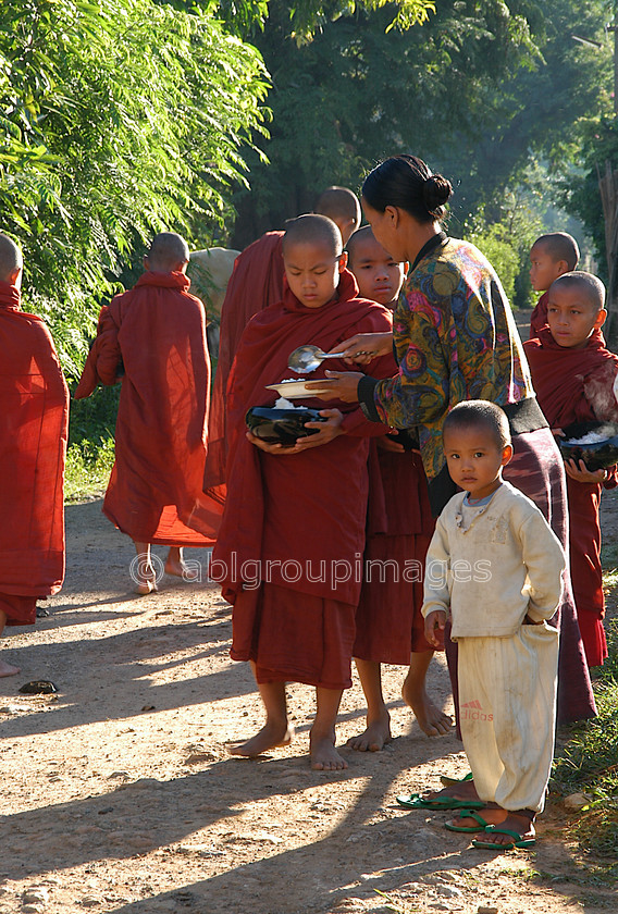 Burma - 01578 
 Inle Lake - Monks early morning food pickup from the local villagers 
 Keywords: Boy, Burma, male, Child, Myanmar, religion, Asia, monk