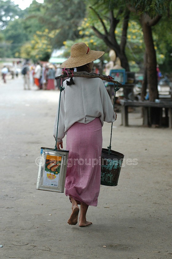 Burma - 00805 
 Water Carrier, Mandalay - Mingun Tour 
 Keywords: women, Asia, Burma, Portrait, female, Myanmar, Woman, Bagan