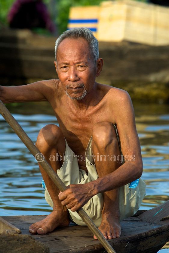 Cambodia -375 
 Cruising - at Floating Village of Chong Kneas on Tonle Sap 
 Keywords: Asia, Cambodia, canoe, , Man, Old Man, People, Siem Reap, transportation, water transportation