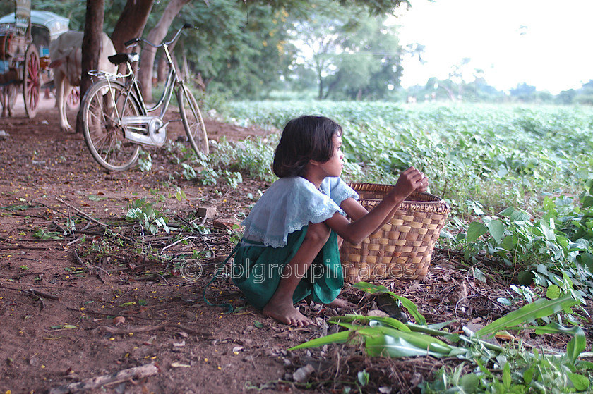 Burma - 00567 
 Young girl with bycycle in background looking out over fields. Mandalay - Inwa (Ava) Tour - 1346 Capital for 400 years 
 Keywords: People, Asia, Girl, Bagan, female, Myanmar, Burma