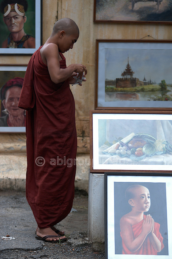 Burma - 00668 
 Monk looking at pictures in a gallery, Central Manadalay - Shwenandaw Monastry and area 
 Keywords: OCCUPATION, Bagan, male, Burma, Man, Myanmar, religion, Asia, Portrait, monk