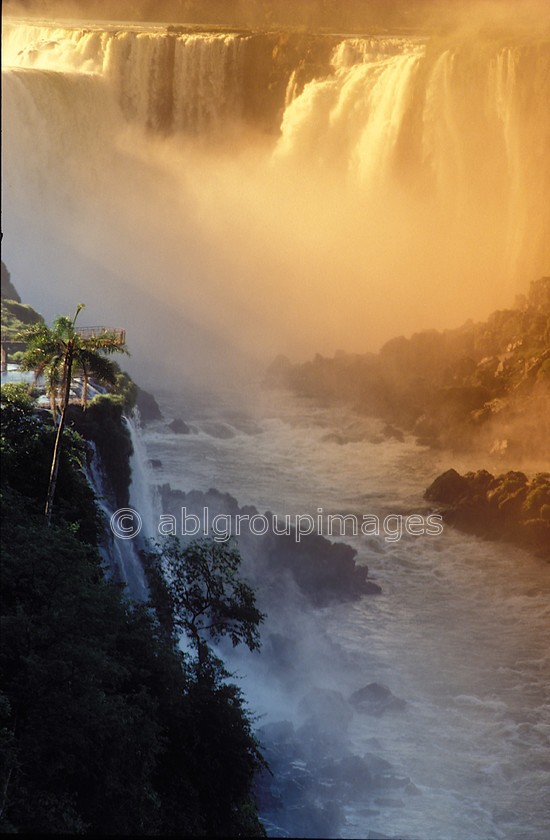 BRA281 
 Iguassu Falls, The waterfall system consists of 275 falls along 2.7 kilometres (1.7 mi) of the Iguazu River. Some of the individual falls are up to 82 metres (269 ft) in height, though the majority are about 64 metres (210 ft). The Devil's Throat, a U-shaped, 82-meter-high, 150-meter-wide and 700-meter-long (490 by 2300 feet) cataract, is the most impressive of all, and marks the border between Argentina and Brazil. 
 Keywords: Brasil, Day, Iguassu, waterfall, Landscape, Portrait, South America, Brazil, water