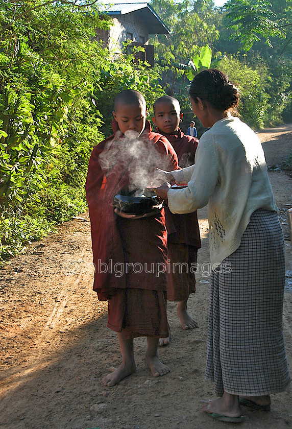 Burma - 01570 
 Inle Lake - Monks early morning food pickup from the local villagers 
 Keywords: religion, Myanmar, Child, male, Boy, Asia, monk, Burma