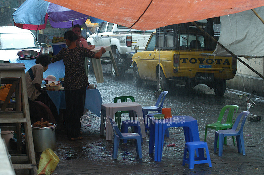 Burma - 00077 
 Tea shop in the rain Bogyoke Aung San Market - 70 Year old Market (British Name: Scott Market) 
 Keywords: Asia, shower, Yangon, rain, Market, Myanmar, rainfall, Burma, rainshower, rainstorm, weather