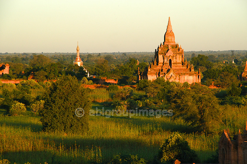 Burma - 01380 
 Stupas and Nats in the evening sunlight, Bagan Plain 
 Keywords: architecture, building, Stupa, Burma, Bagan, Myanmar, religious building, Sunset, Asia