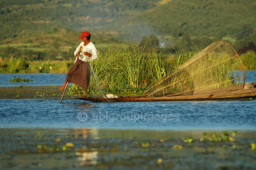 Burma - 01842 
 Inle Lake - Fisherman, leg rowing and holding net 
 Keywords: Burma, Myanmar, Asia, Man, male