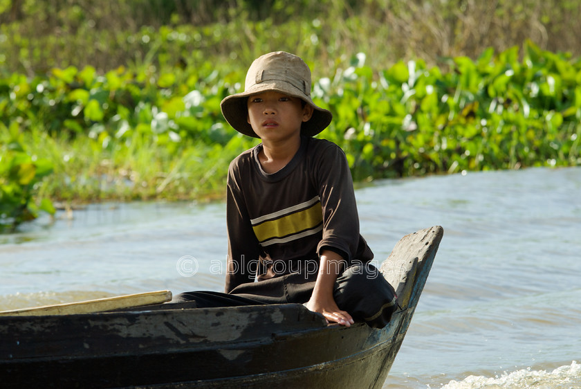 Cambodia -303 
 Boy in Boat - at Floating Village of Chong Kneas on Tonle Sap 
 Keywords: Asia, Boy, Cambodia, canoe, , People, Siem Reap, transport, transportation, water transportation