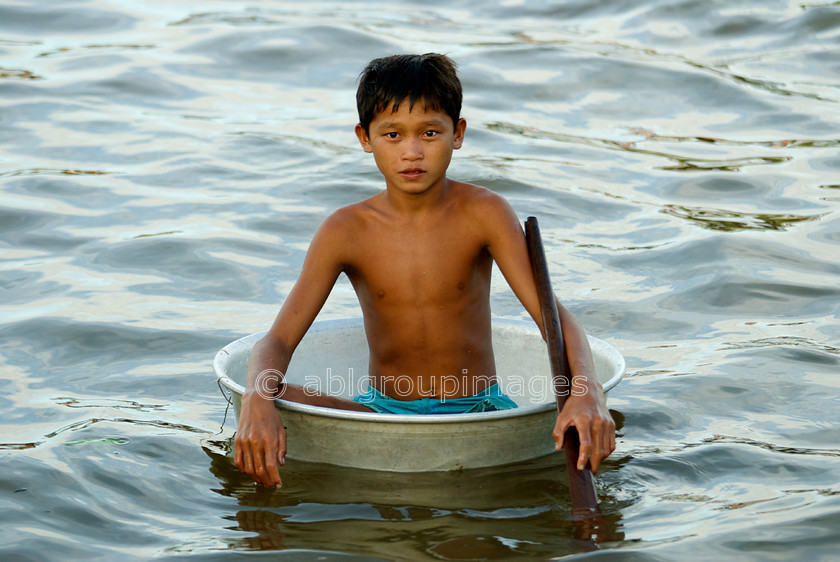 Cambodia -403 
 Young boy in a bowl to float around - at Floating Village of Chong Kneas on Tonle Sap 
 Keywords: Asia, Boy, Cambodia, , Home, People, Siem Reap, transport, transportation, water transportation