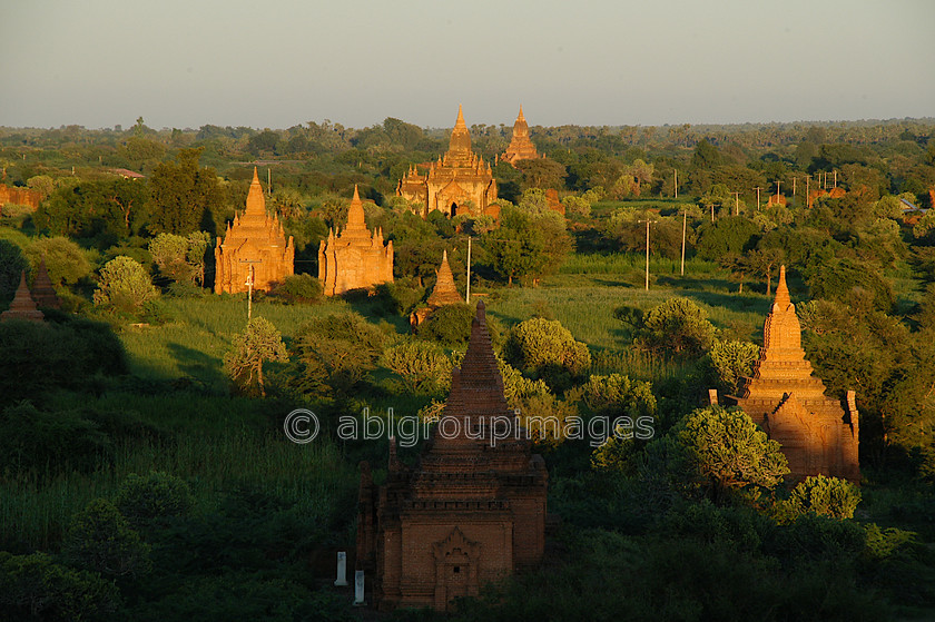 Burma - 01382 
 Stupas and Nats in the evening sunlight, Bagan Plain 
 Keywords: Asia, religious building, Burma, architecture, Stupa, Bagan, Sunset, building, Myanmar