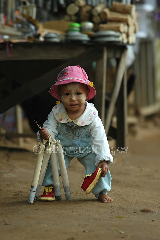 Burma - 00758 
 Child playing and picking up lost shoe, Mandalay - Mingun Tour 
 Keywords: Asia, Child, Children, Myanmar, People, Burma