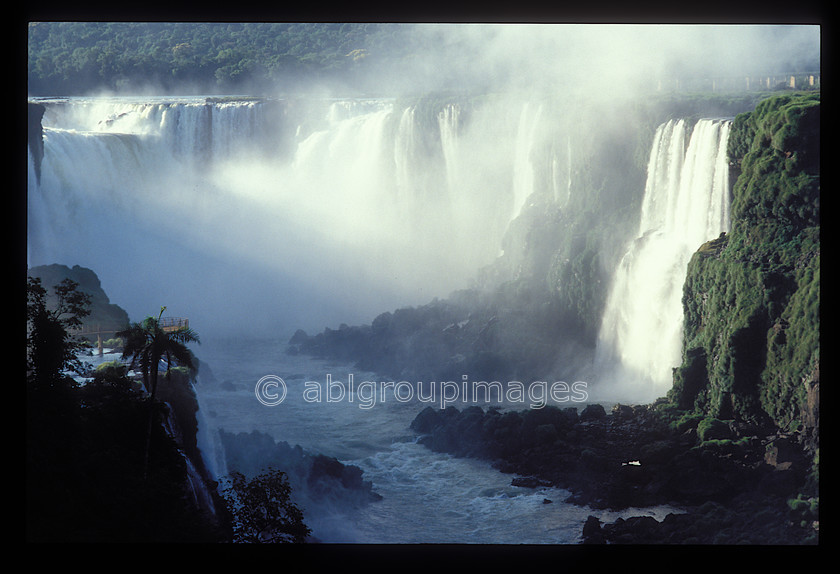 BRA258 
 Iguassu Falls, The waterfall system consists of 275 falls along 2.7 kilometres (1.7 mi) of the Iguazu River. Some of the individual falls are up to 82 metres (269 ft) in height, though the majority are about 64 metres (210 ft). The Devil's Throat, a U-shaped, 82-meter-high, 150-meter-wide and 700-meter-long (490 by 2300 feet) cataract, is the most impressive of all, and marks the border between Argentina and Brazil. 
 Keywords: waterfall, water, Iguassu, Brazil, Brasil, South America