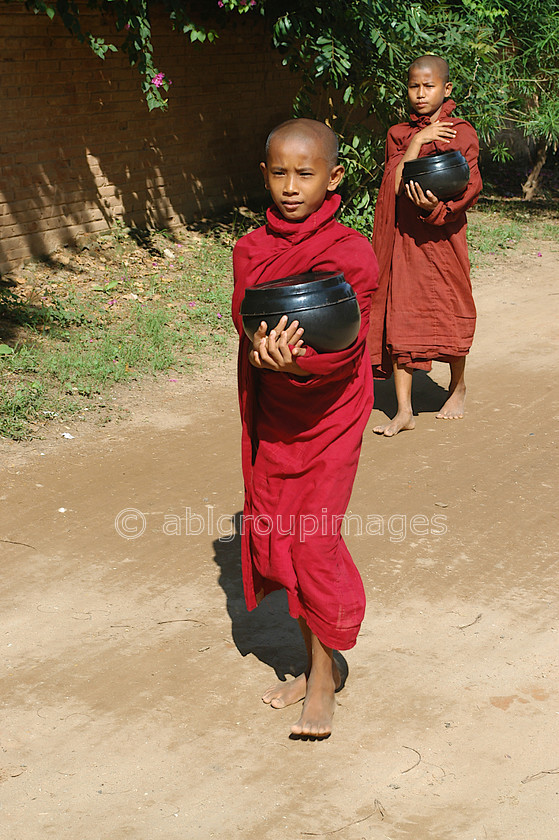 Burma - 00376 
 Monks with food bowl on Bagan Plain - Temples of Bagan 
 Keywords: Buddhism, monk, male, religion, Boy, Portrait, Myanmar, Burma, Asia, Bagan, OCCUPATION, Ayeyarwady River