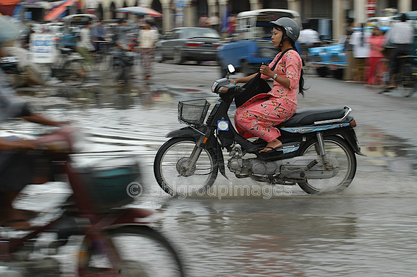 Burma - 00650 
 Central Manadalay - Lady on the Bike 
 Keywords: Asia, Burma, land transportation, motorcycle, Myanmar, People, transportation, Woman