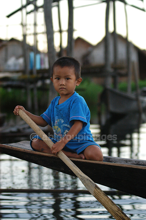 Burma - 02069 
 Inle Lake - Boy on canoe 
 Keywords: Boy, Myanmar, male, Portrait, Burma, Asia