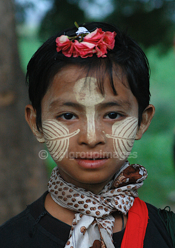 Burma - 00580 
 Boy with decorated face Mandalay - Inwa (Ava) Tour - 1346 Capital for 400 years 
 Keywords: Myanmar, Boy, Bagan, male, Burma, Portrait, Asia