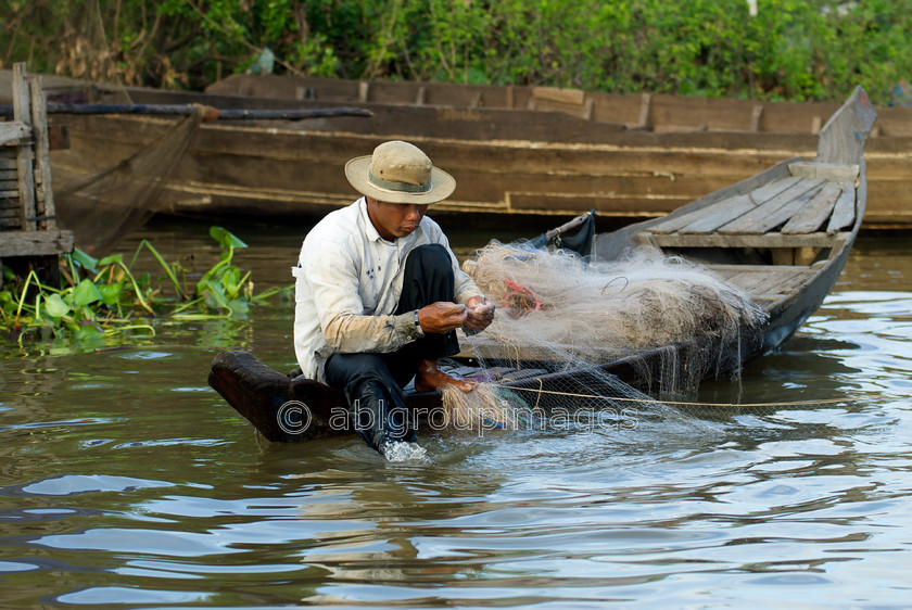 Cambodia -381 
 Fisherman with nets - at Floating Village of Chong Kneas on Tonle Sap 
 Keywords: Asia, Cambodia, canoe, fisherman, , Man, OCCUPATION, People, Siem Reap, transportation, water transportation